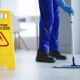 Front view of a janitor mopping the floor