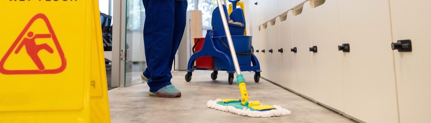 Side view of a janitor mopping the floor