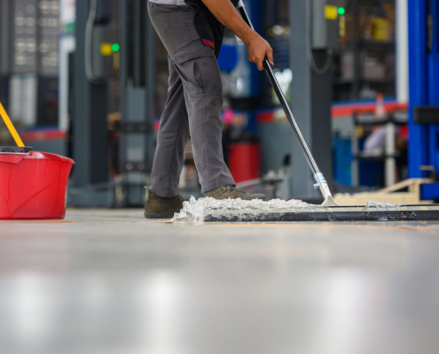 Side view of someone mopping warehouse floor