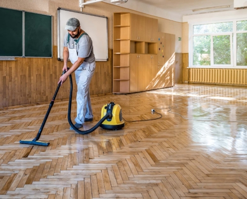 Worker cleaning floors at school